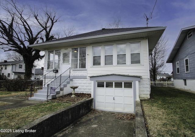 view of front facade with a garage and a yard