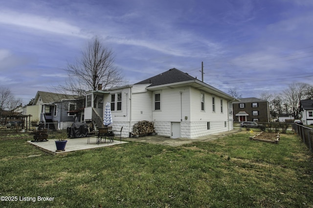 back of property with a patio and a lawn