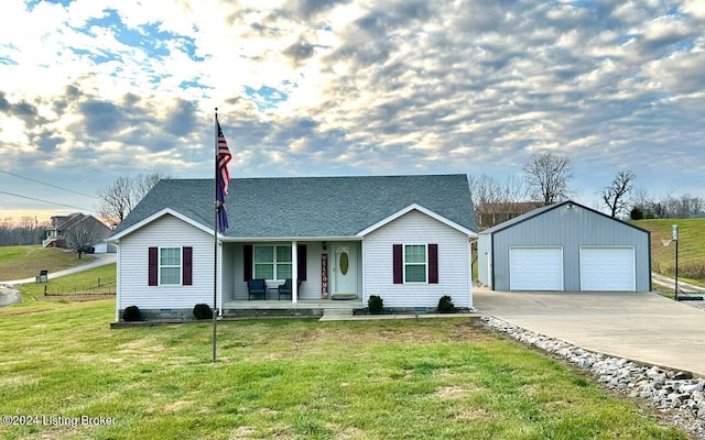 ranch-style house featuring covered porch, a garage, an outbuilding, and a front lawn