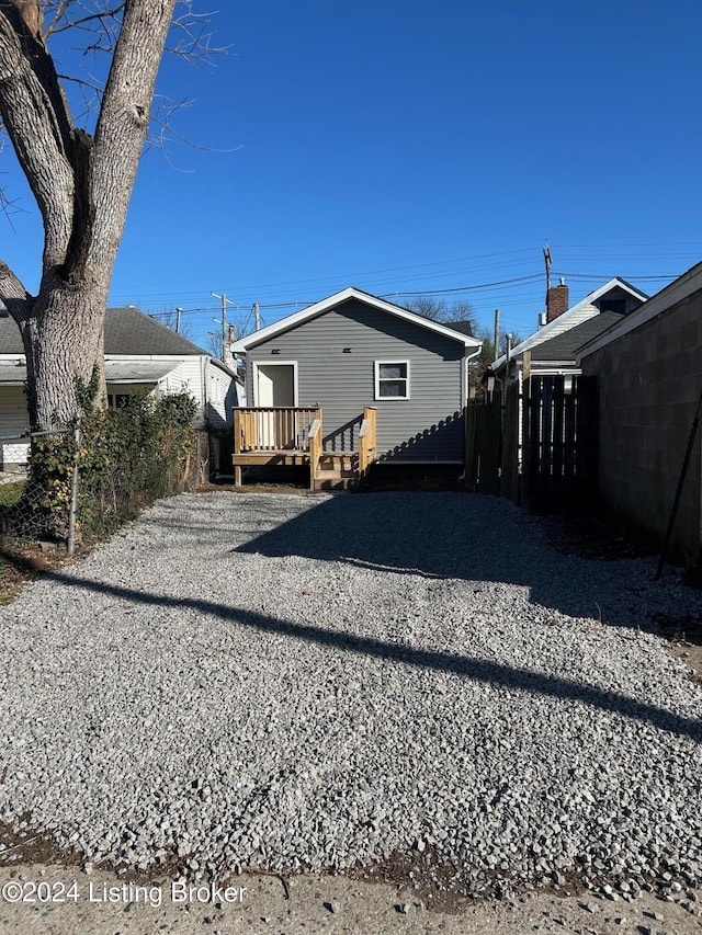 back of house with a deck