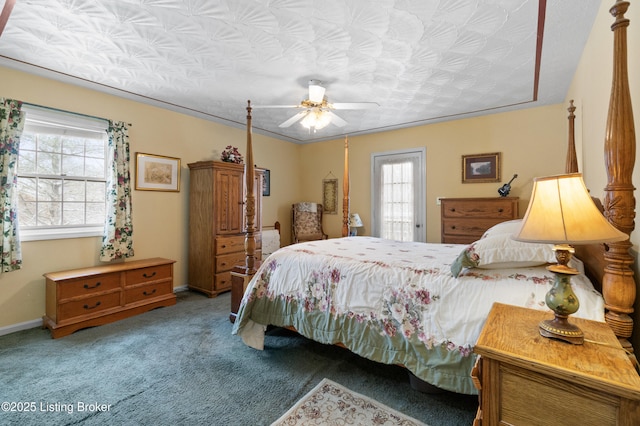 carpeted bedroom featuring a textured ceiling and ceiling fan