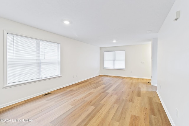 empty room with light hardwood / wood-style floors