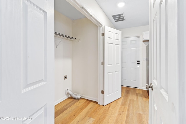 clothes washing area with electric dryer hookup and light hardwood / wood-style floors