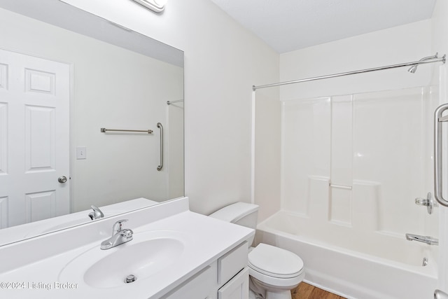 full bathroom with toilet, vanity, and washtub / shower combination