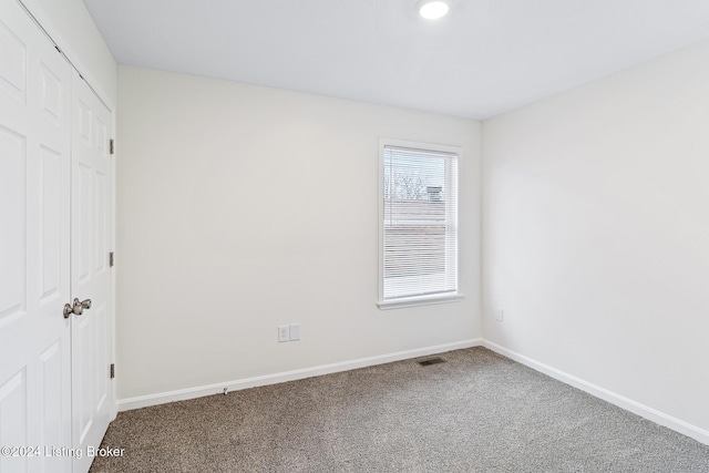 unfurnished bedroom with a closet and carpet