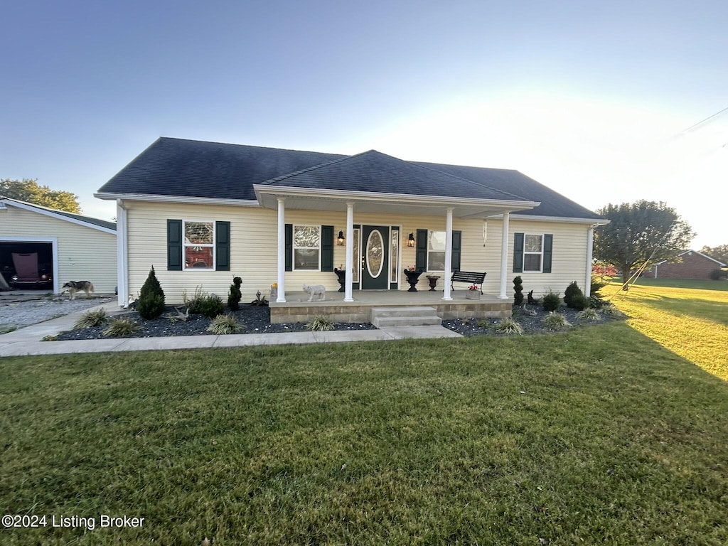 view of front of home featuring a front yard and a porch