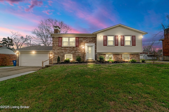 view of front of house with a garage and a yard