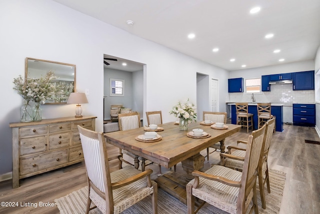 dining space with hardwood / wood-style flooring