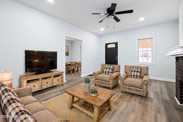 living room with hardwood / wood-style floors and ceiling fan