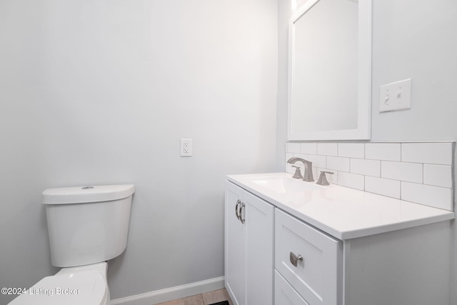 bathroom with tasteful backsplash, vanity, and toilet