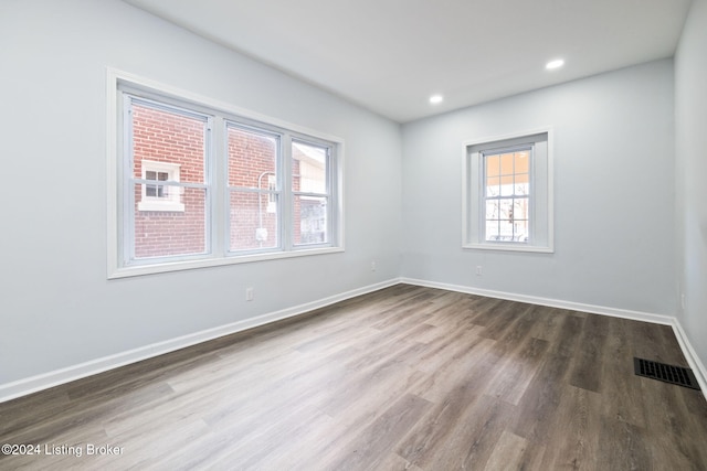 unfurnished room featuring dark hardwood / wood-style flooring