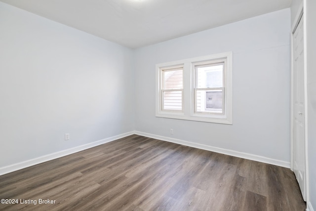 unfurnished room featuring dark hardwood / wood-style flooring