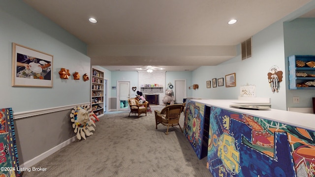 bedroom featuring a fireplace and light colored carpet