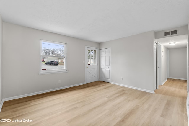 spare room with light hardwood / wood-style flooring