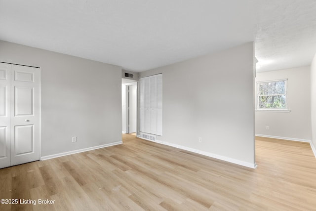 spare room featuring light wood-type flooring