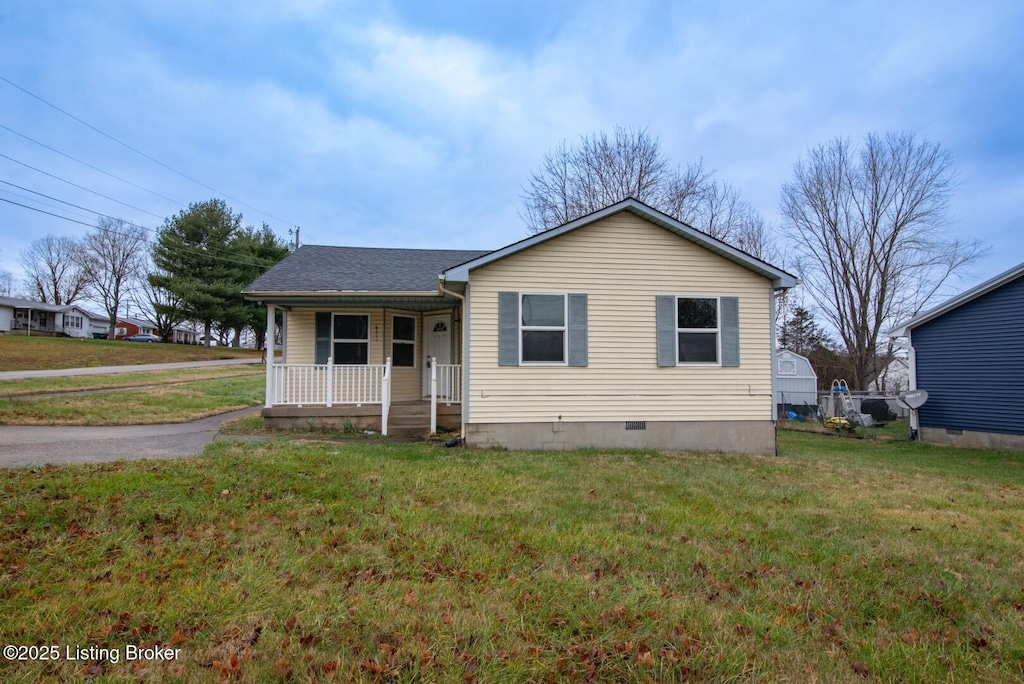 view of front of house with a front yard and a porch