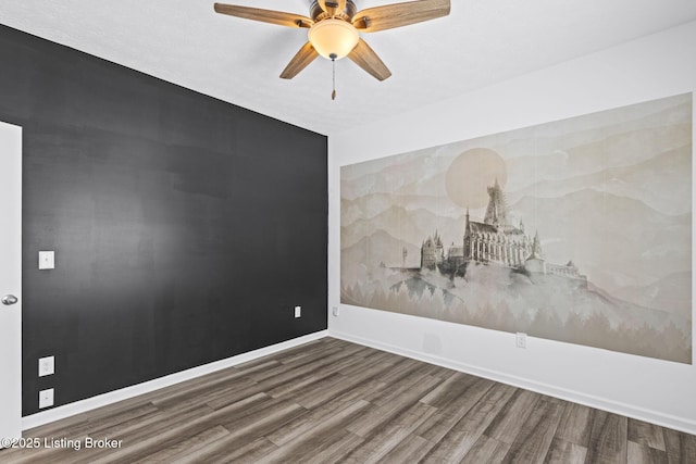 empty room featuring hardwood / wood-style floors and ceiling fan