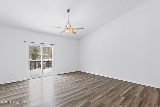 spare room with vaulted ceiling, hardwood / wood-style floors, a textured ceiling, and ceiling fan