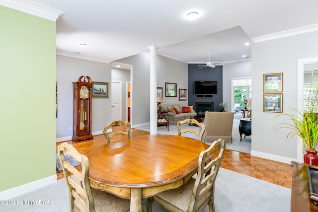 dining space with ceiling fan, light parquet flooring, and ornamental molding