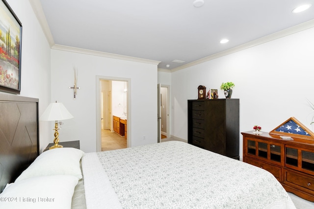 bedroom with connected bathroom and crown molding