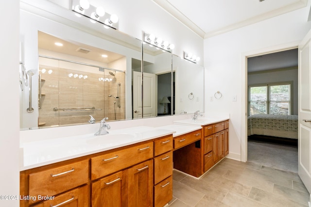 bathroom with vanity, a shower with door, and crown molding