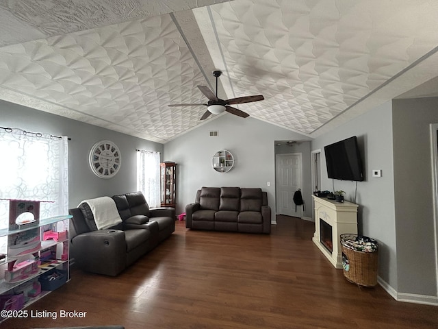 living room featuring hardwood / wood-style flooring, ceiling fan, and lofted ceiling