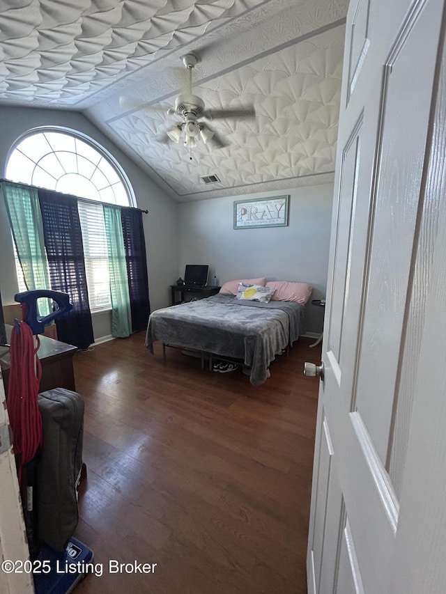 bedroom featuring ceiling fan, wood-type flooring, and lofted ceiling