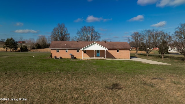 rear view of house featuring a yard