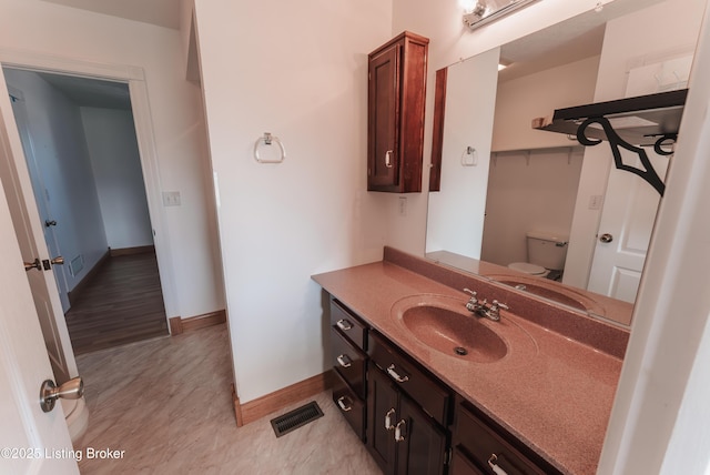 bathroom featuring vanity and toilet