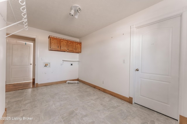 laundry area with hookup for an electric dryer, hookup for a washing machine, and cabinets