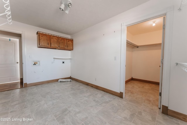 clothes washing area featuring cabinets, hookup for a washing machine, and electric dryer hookup