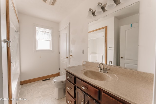 bathroom with vanity, a shower with shower curtain, and toilet