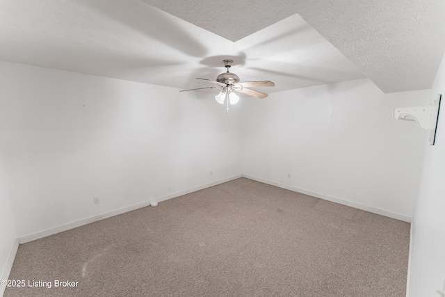 spare room featuring carpet, ceiling fan, and a textured ceiling