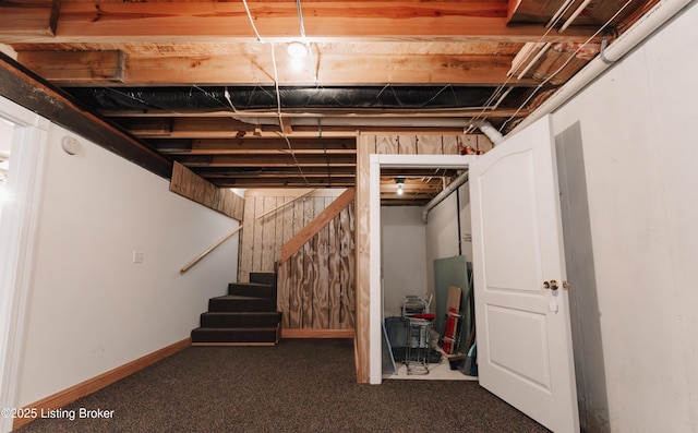 basement with dark colored carpet