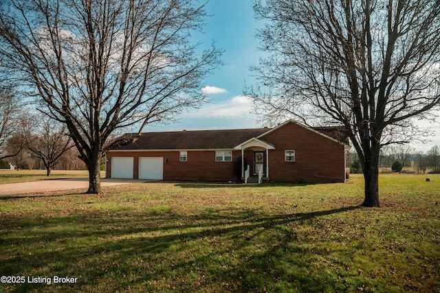 ranch-style home with a garage and a front lawn