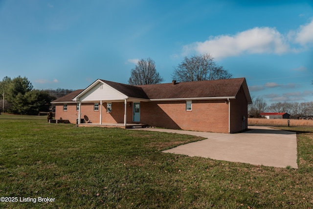 back of property featuring a lawn