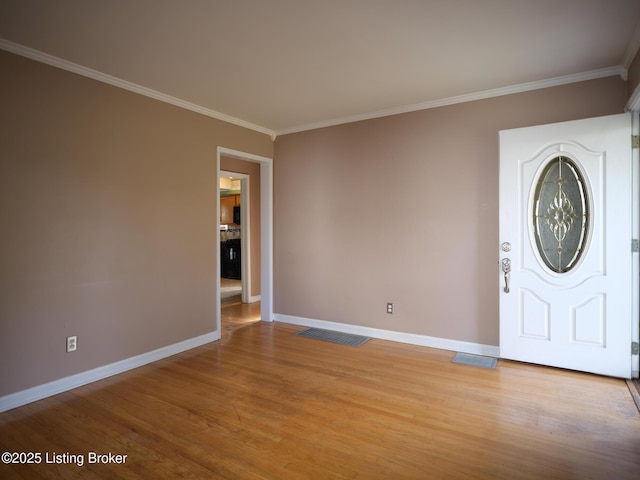 foyer with wood-type flooring and ornamental molding