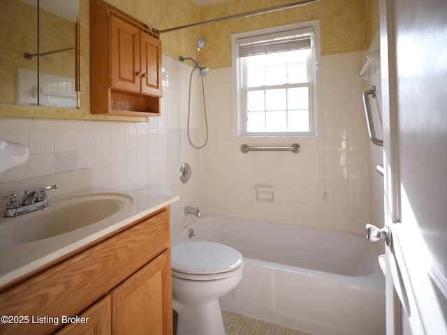 full bathroom with vanity, tiled shower / bath, toilet, tile walls, and tasteful backsplash