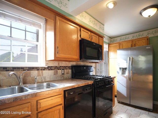 kitchen with backsplash, sink, and black appliances