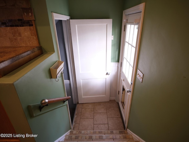 doorway to outside with plenty of natural light and light tile patterned floors