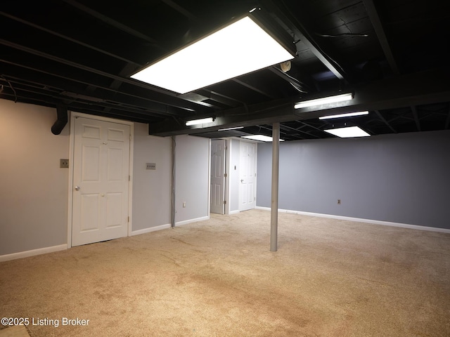 basement featuring light colored carpet