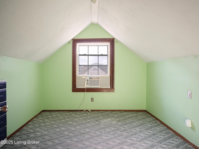 additional living space featuring carpet flooring, cooling unit, lofted ceiling, and a textured ceiling