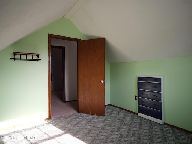 additional living space with carpet flooring and lofted ceiling