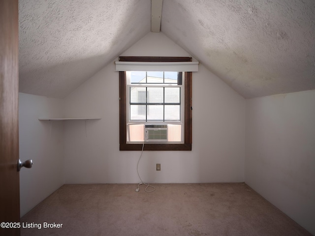 additional living space with lofted ceiling, cooling unit, carpet floors, and a textured ceiling