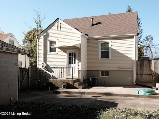 rear view of property with central AC unit