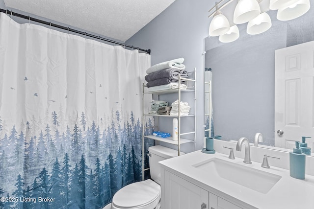 bathroom featuring a shower with shower curtain, vanity, toilet, and a textured ceiling