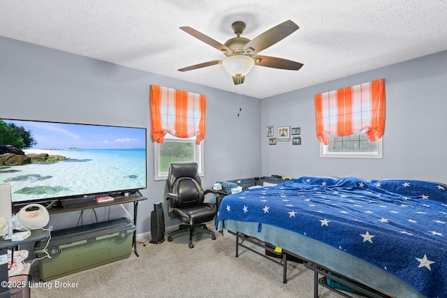 bedroom featuring carpet flooring, ceiling fan, and a textured ceiling