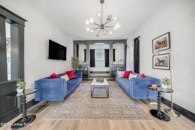 living room featuring hardwood / wood-style flooring and a notable chandelier