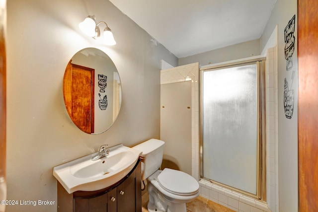 bathroom featuring toilet, vanity, and walk in shower