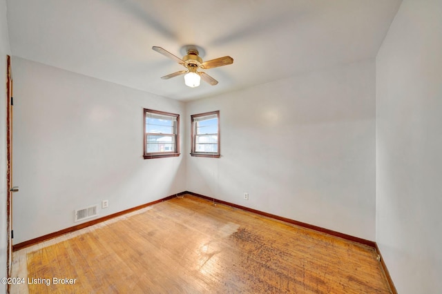 unfurnished room with ceiling fan and hardwood / wood-style flooring